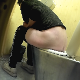 A mature, Eastern-European woman takes a piss and a shit while sitting on a public steel toilet. She crouches in the corner of the bathroom to wipe. No audible pooping sounds. Presented in 720P HD. Over 2 minutes.